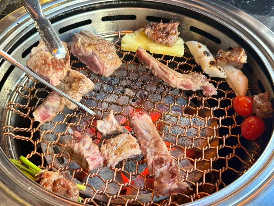 Seasoned galbi marinated in garlic sauce being grilled