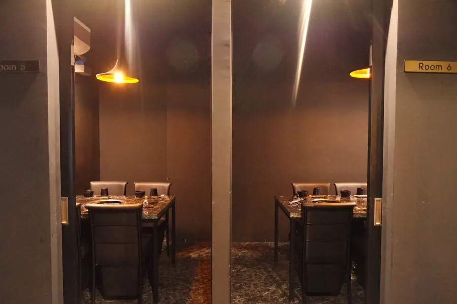 Private room seating with black-toned interior