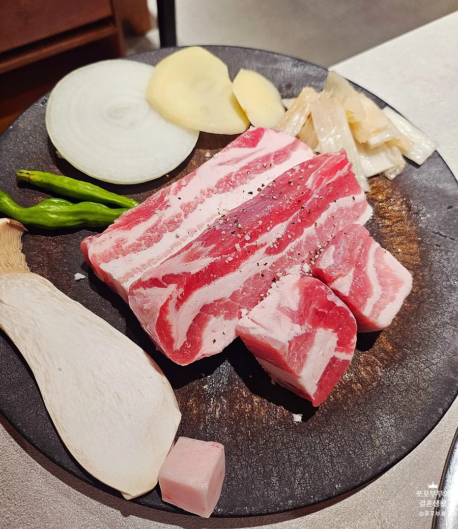 Aged pork belly grilling at a booth seat