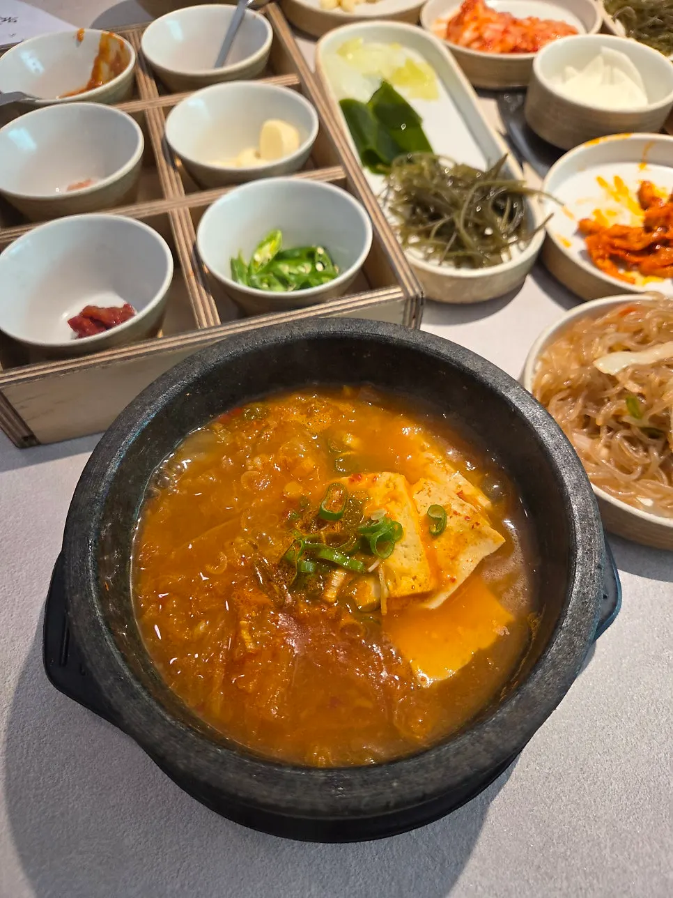 Kimchi jjigae served in a stone pot