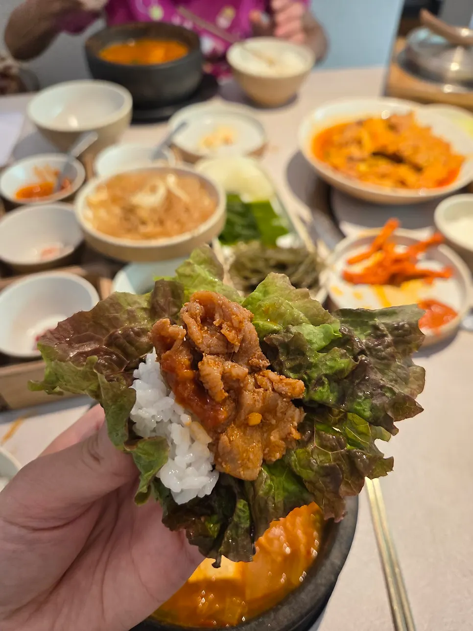 Stir-fried pork placed on a cabbage leaf wrap