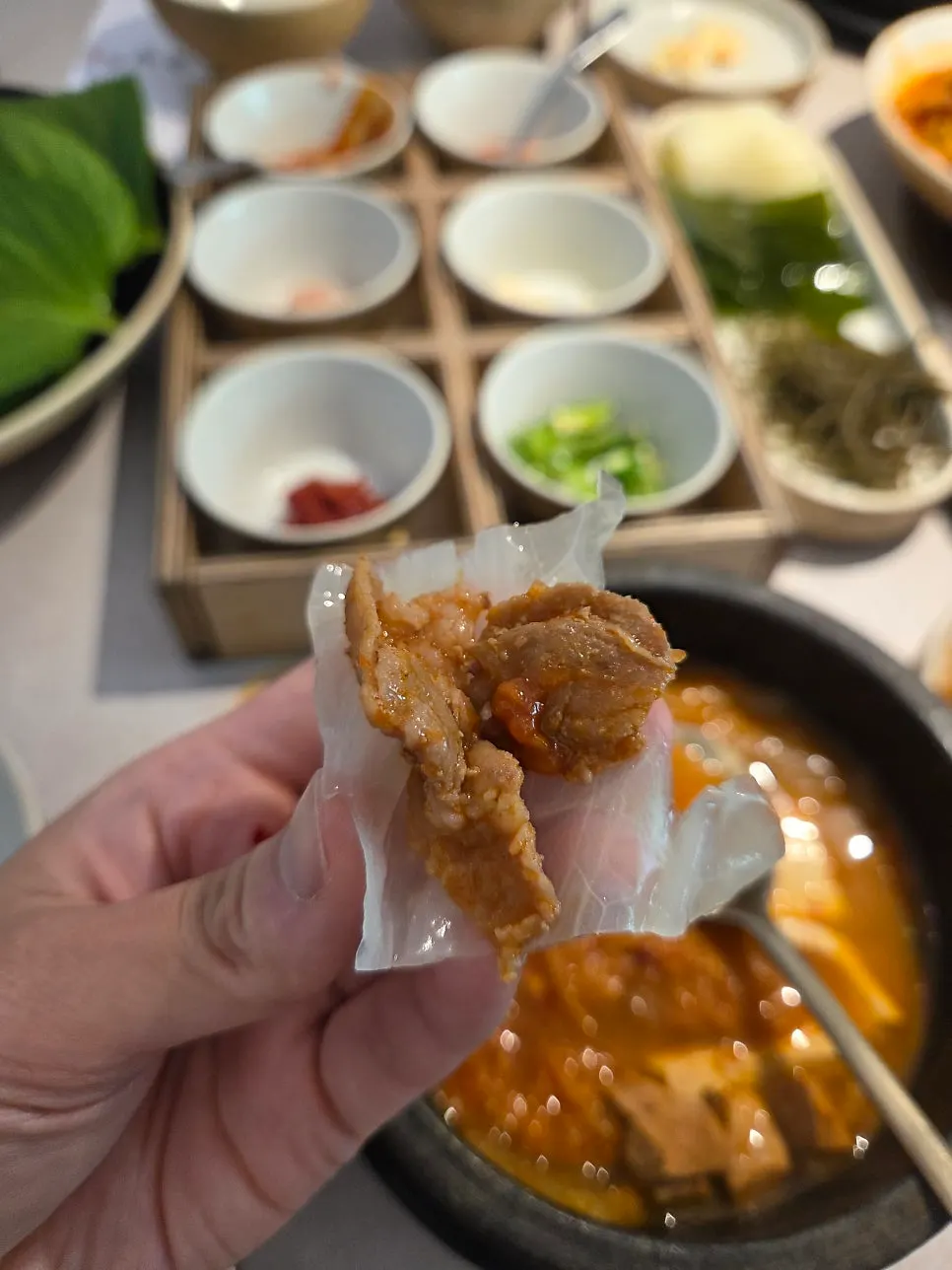 A bite of the ssambap jeongsik wrapped in leaves