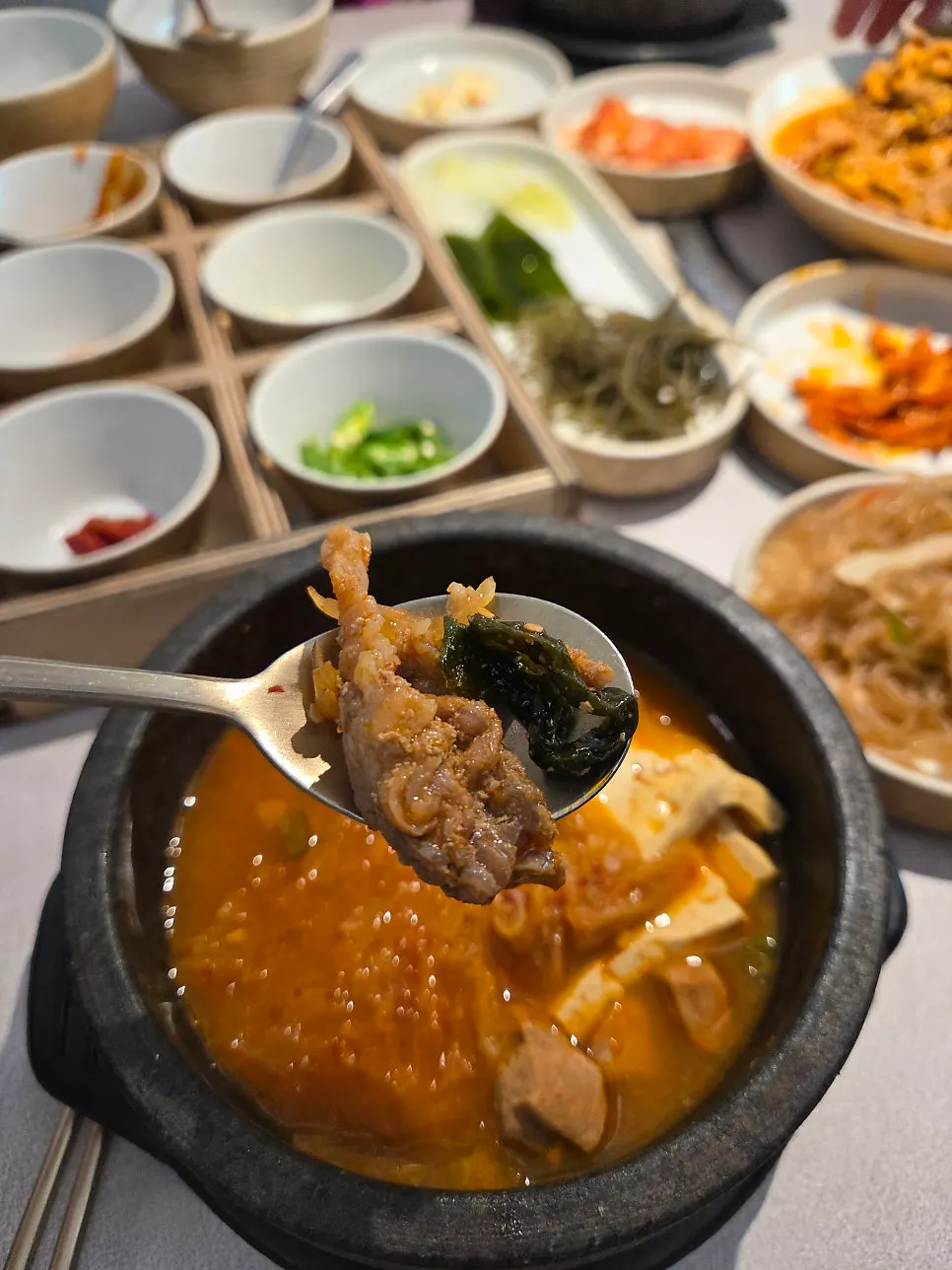 Table mid-meal with side dishes and jjigae from the ssambap jeongsik