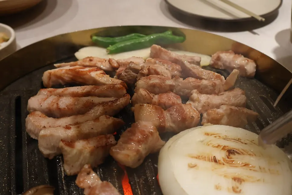 익어가는 고기와 함께 놓인 사이드 메뉴