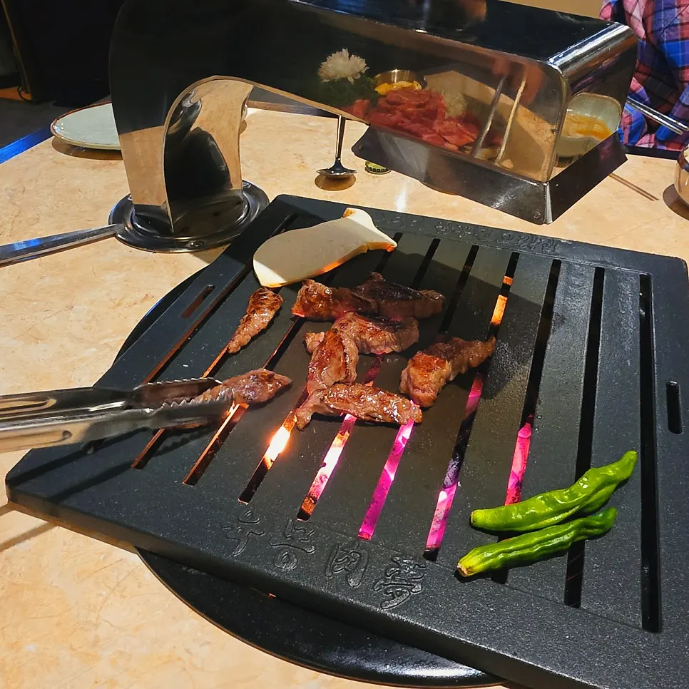 Meat being grilled by staff