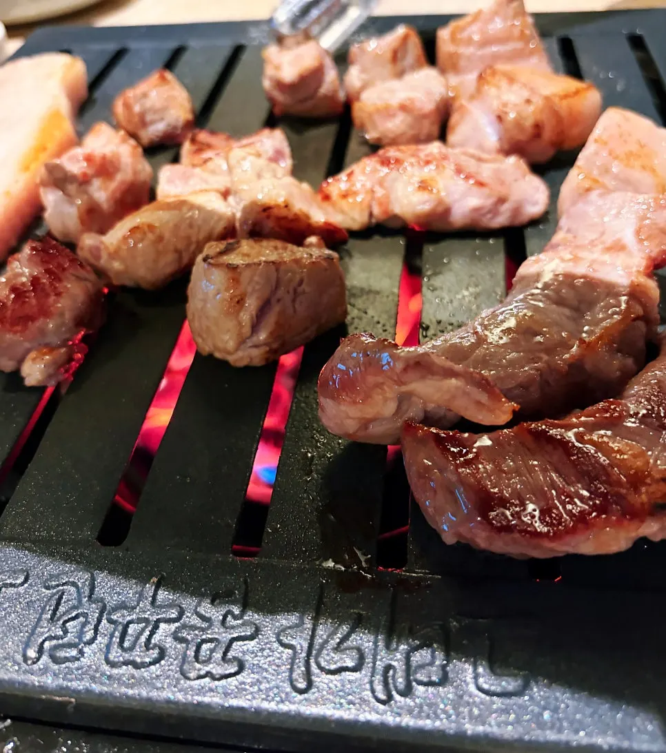 Grilled Korean pork on a black iron plate