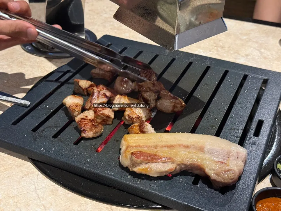 Three cuts of Korean pork cooking on the grill