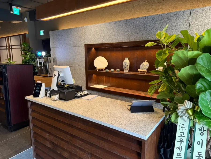 Interior decorated with wood, marble, and indirect lighting