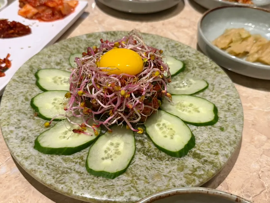 Gochujang lotus minari beef tartare topped with egg yolk