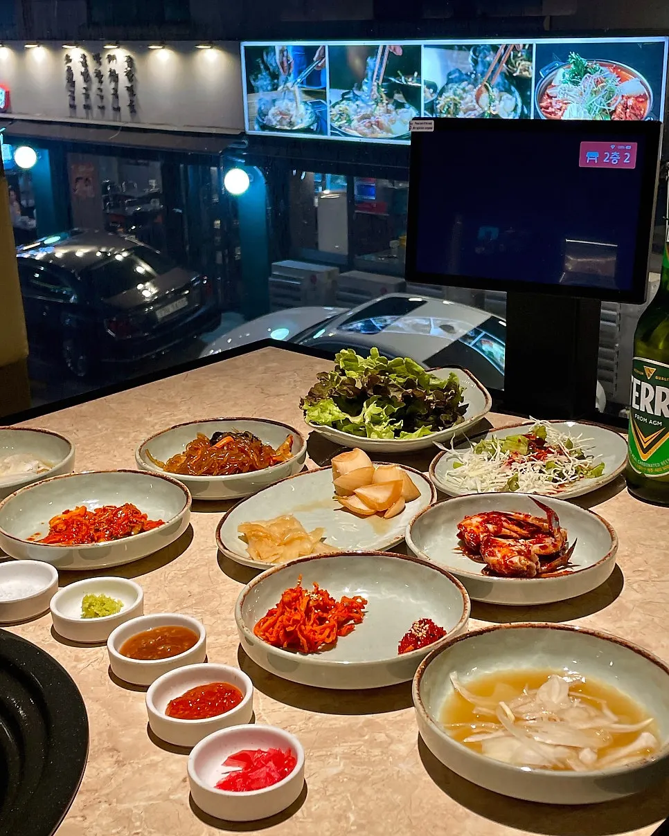 Basic side dishes and sauces laid out at Yukmong