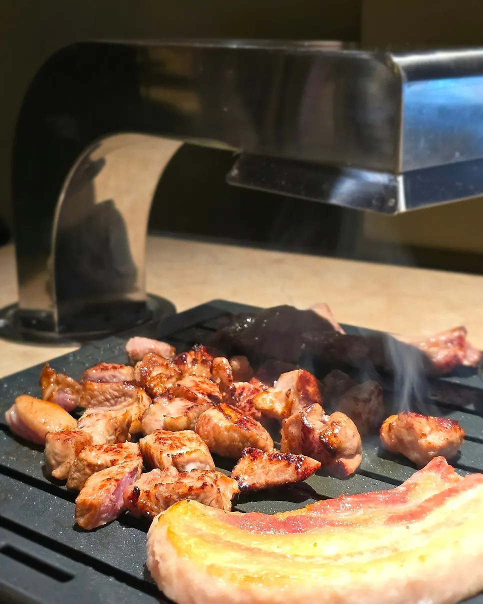 Staff member grilling the meat tableside