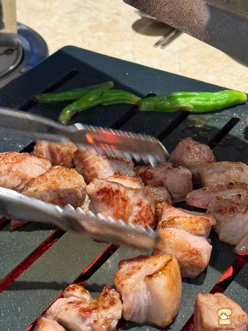 Thick snowflake pork neck cooking on the grill plate