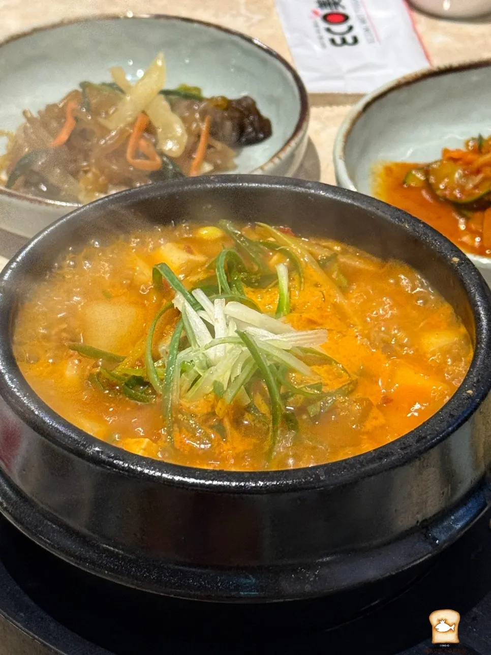 Signature doenjang stew served in an earthenware bowl