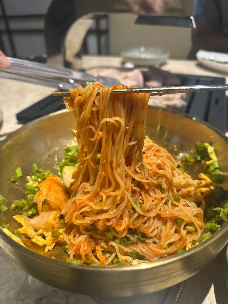 Cheongdo minari bibim noodles piled with minari