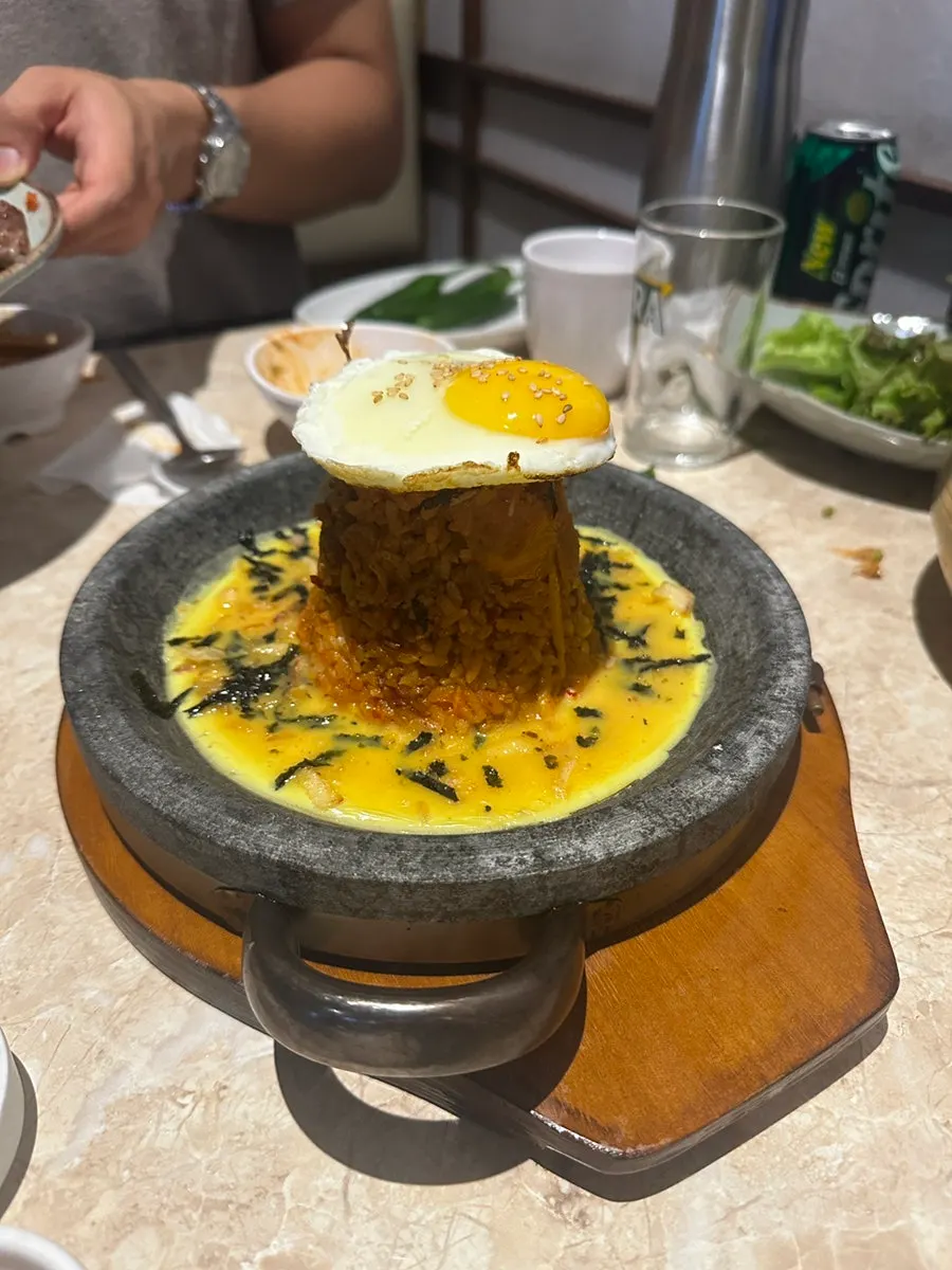 Radish kimchi fried rice topped with an egg crust