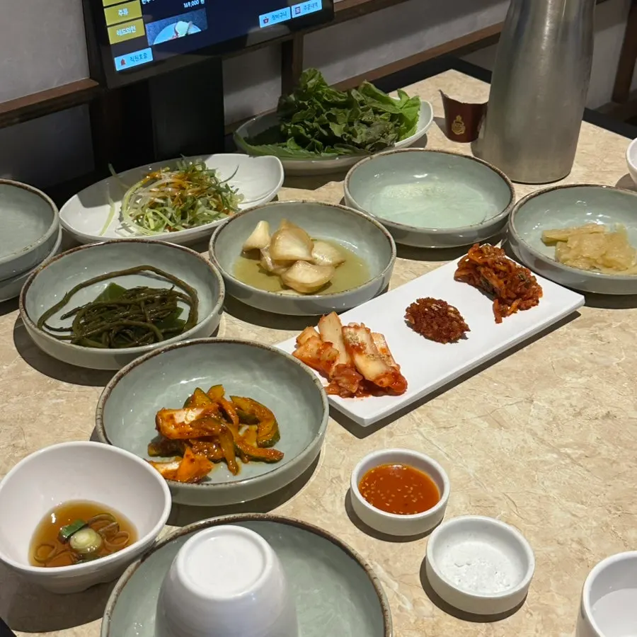 Table of basic side dishes including shredded scallions and spicy-marinated cucumbers