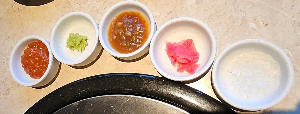 Sauce lineup including ssamjang, Maldon salt, and fish tamarind sauce