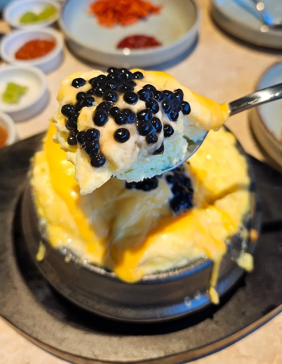 Close-up of caviar on the fluffy egg custard