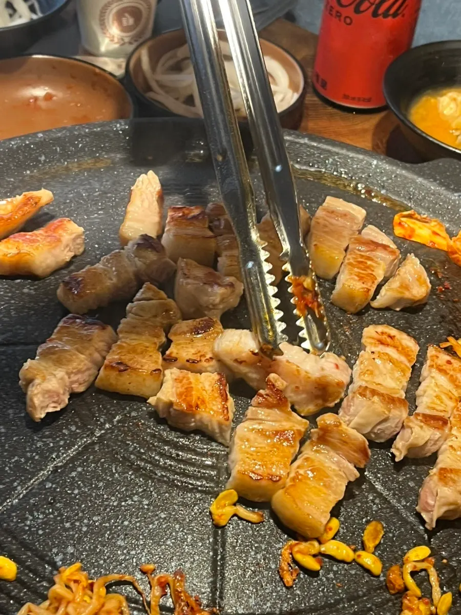 Pork belly and side dishes on the grill