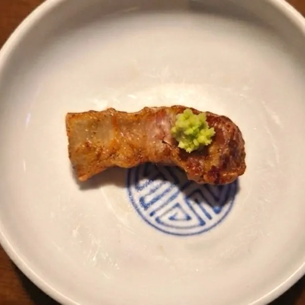 A piece of grilled ogyeopsal at Yuk Tongnyeong Gyodae Branch