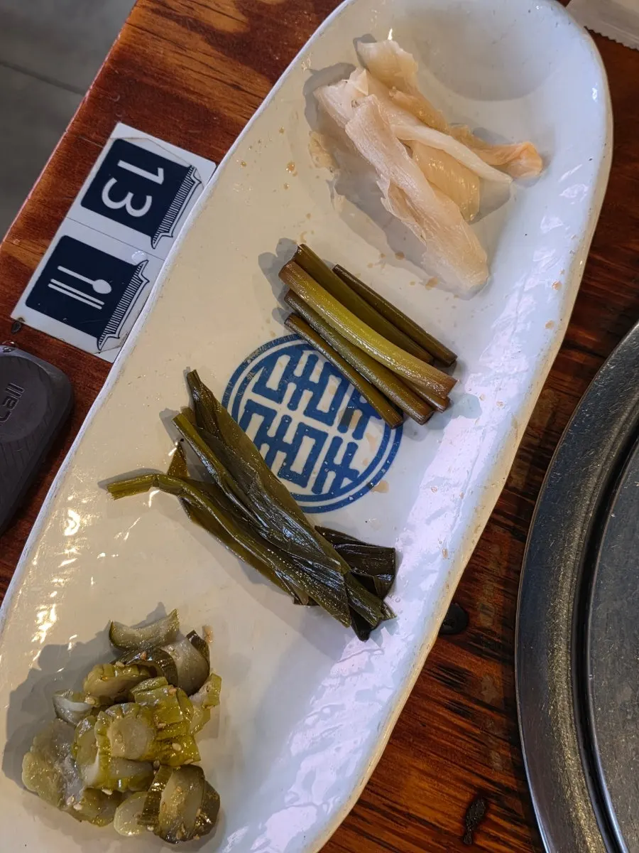 Additional side dishes including pickles and perilla leaf sauce