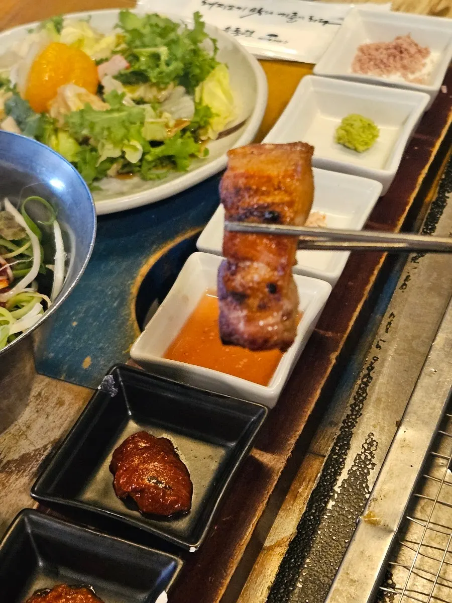 A meal with yukgyeopsal and bibim dongchimi naengmyeon