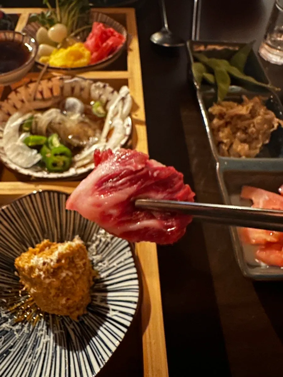 A piece of raw chimasal topped with wasabi