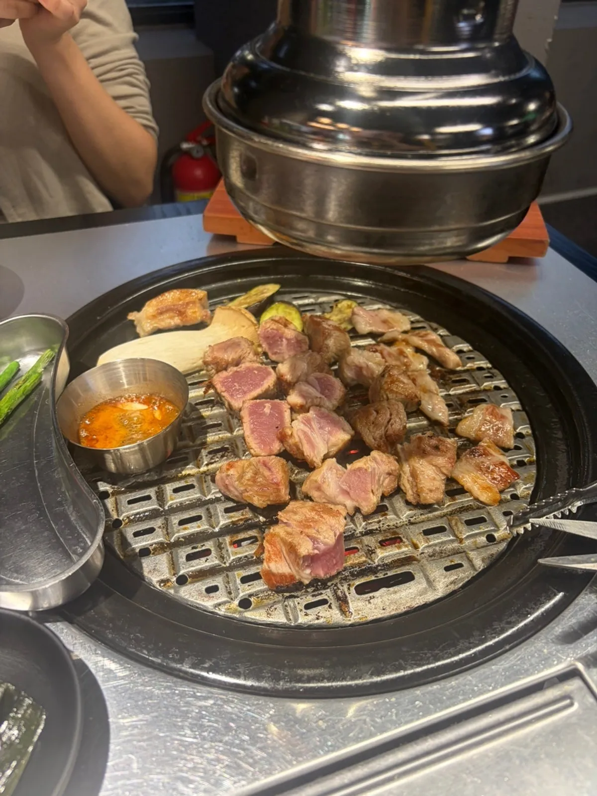 Golden-brown grilled meat and vegetables cooked by staff