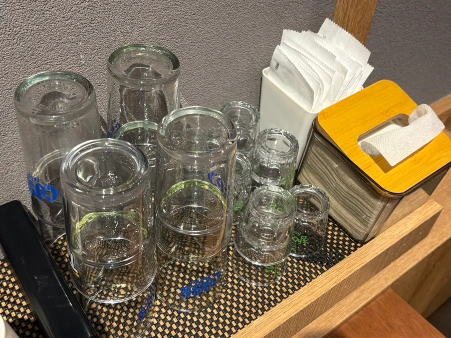 Table setting with small plate, glasses, and wet wipes