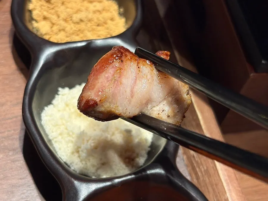 Grilled pork pieces piled on the mini charcoal brazier