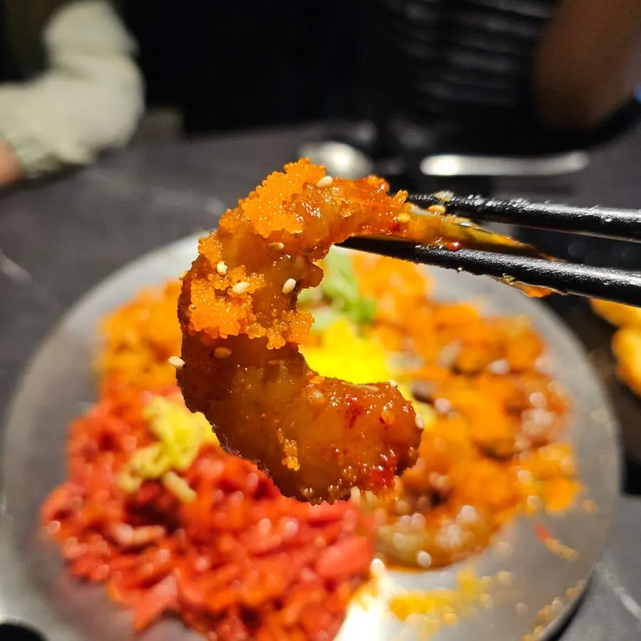A bite of yukhoe shrimp jang kalbibim