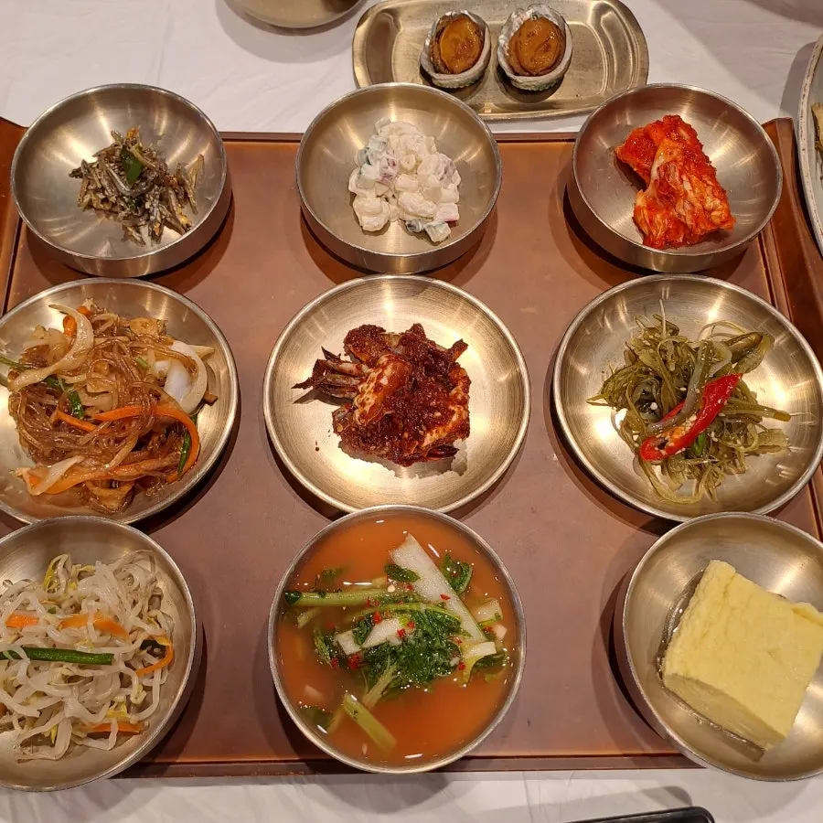 A full table of Korean set meal side dishes at Yun Sikdang