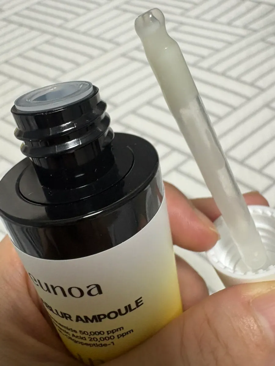 Back of hand with ampoule dispensed from dropper