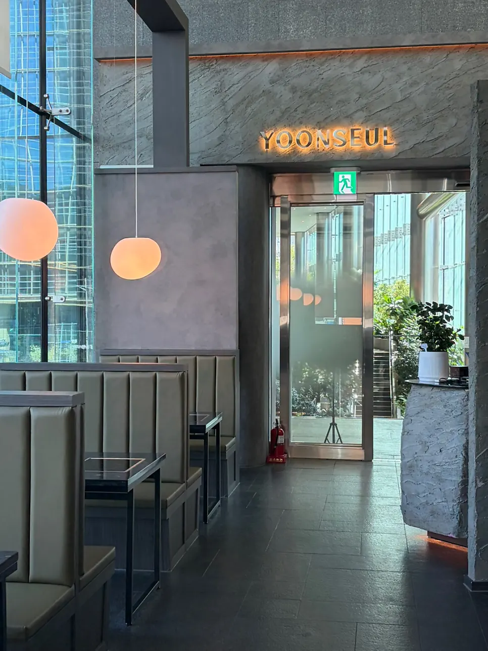 Interior of Yunseul with high ceilings and floor-to-ceiling windows