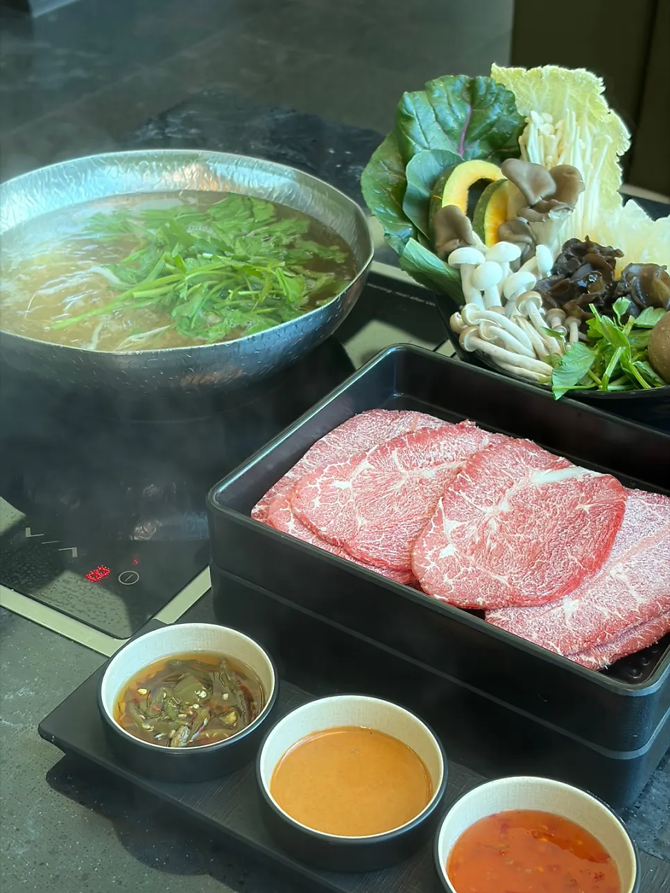 A full spread of Yunseul shabu-shabu with vegetables and mushrooms