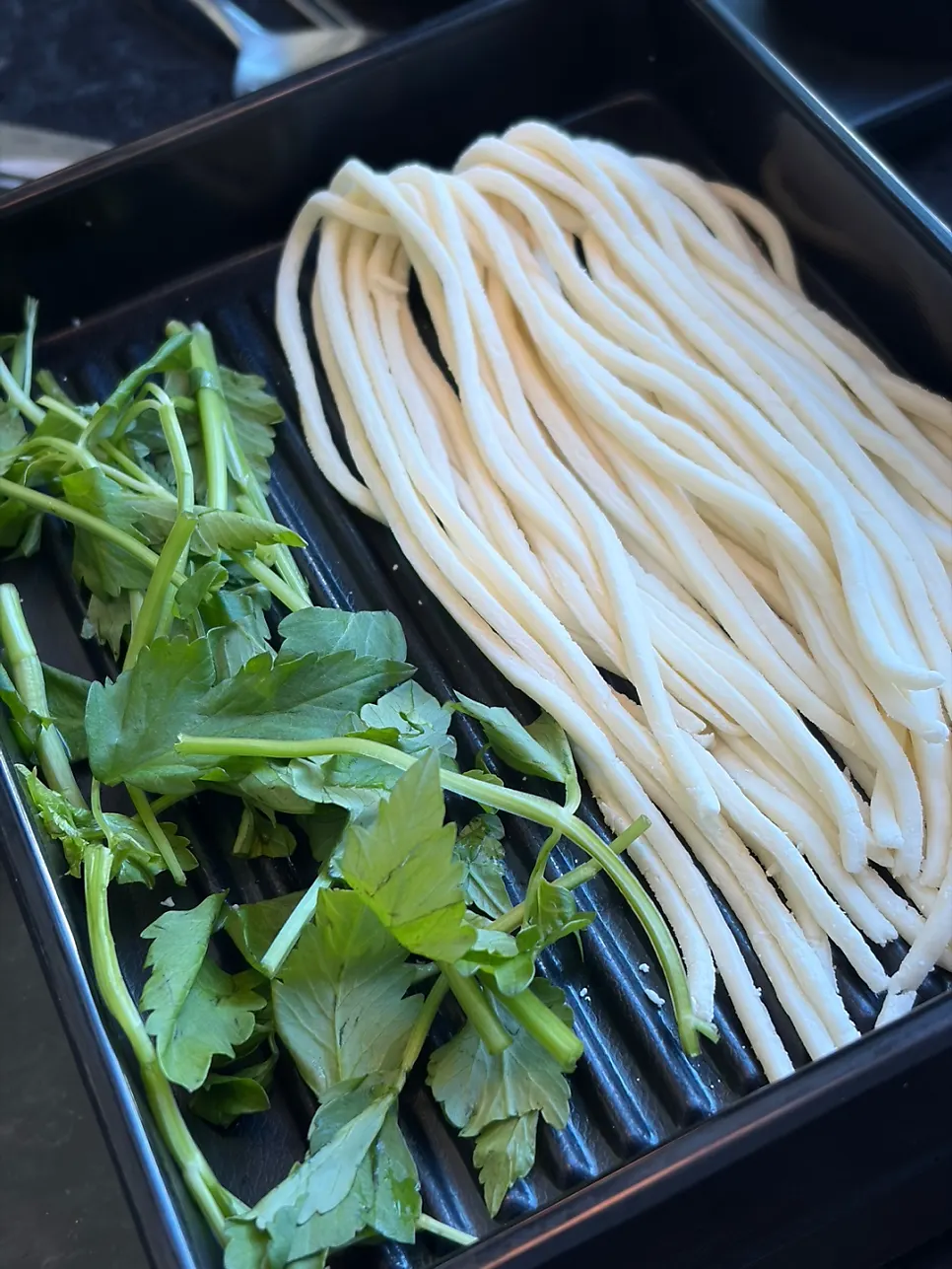 Hand-cut noodles added to the shabu-shabu broth