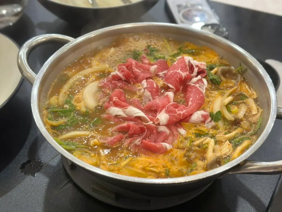 빨간 육수에 고기를 익히는 모습