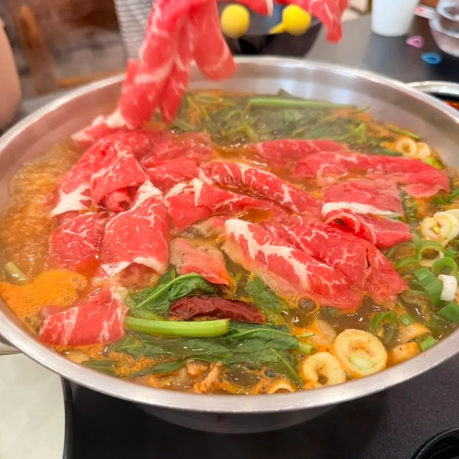 Vegetables going into the boiling broth