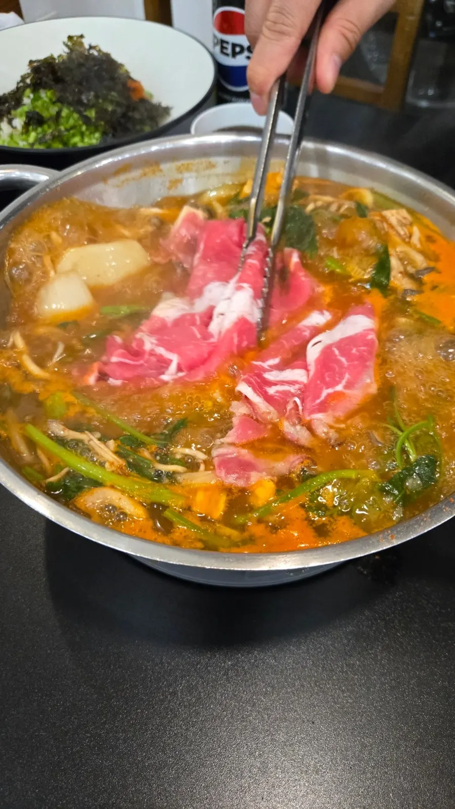 Vertical shot of the table with cola and shabu-kalguksu