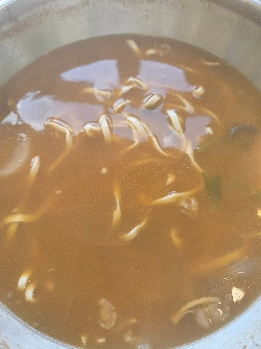 Kalguksu noodles added to the red broth