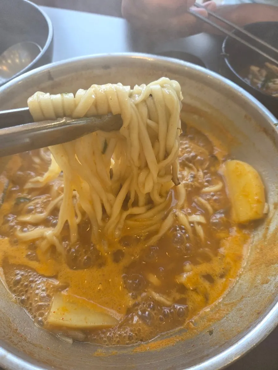 Serving out the kalguksu noodles