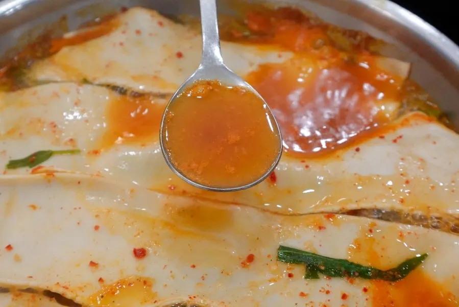 Self-made flat kalguksu noodles torn off one sheet at a time