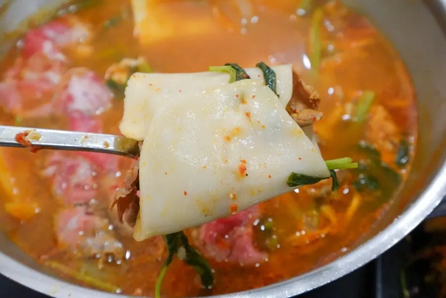 Close-up of a bite of the flat kalguksu wrap