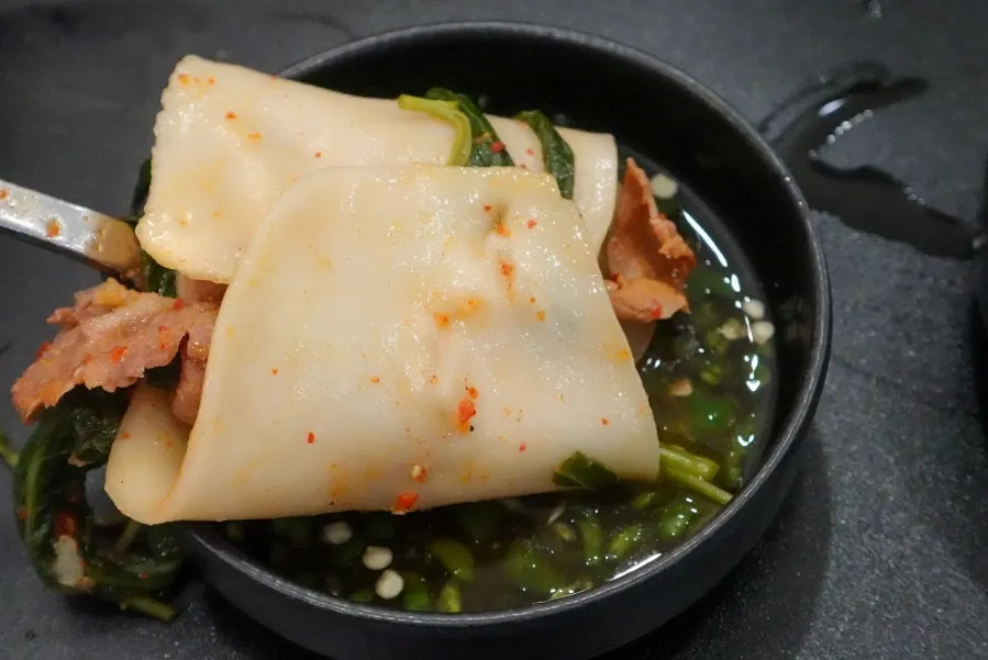Plate of flat kalguksu and meat wraps