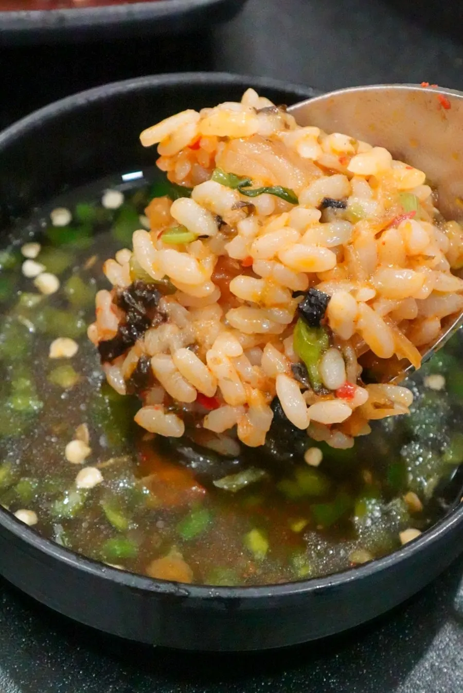A spoonful of the finished fried rice