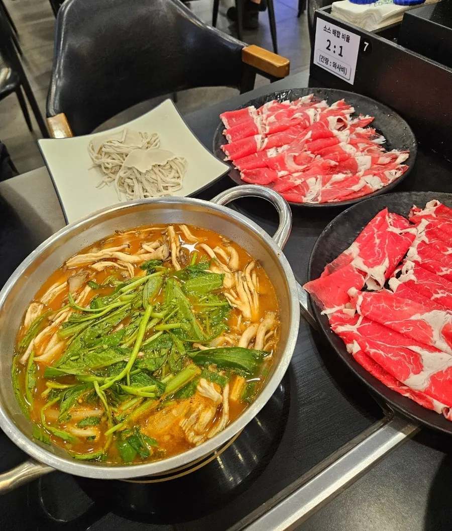 Dipping meat into the broth to blanch it