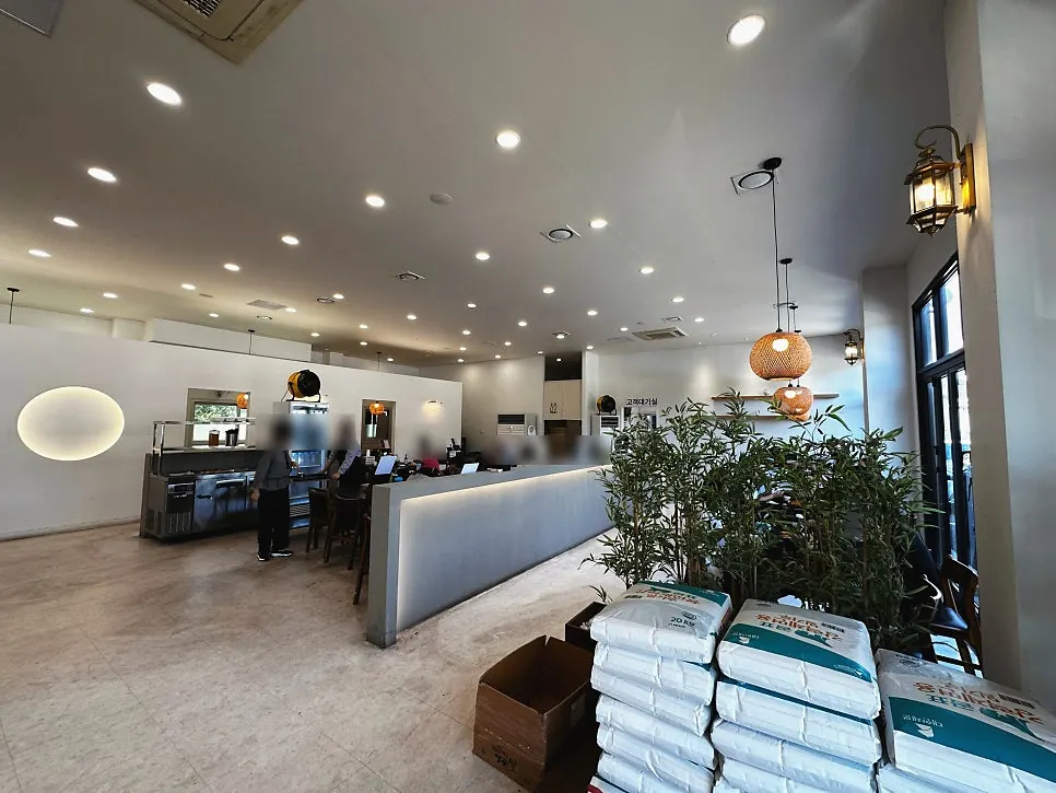 White-toned dining hall seating at Yun Ujae Shabu Kalguksu