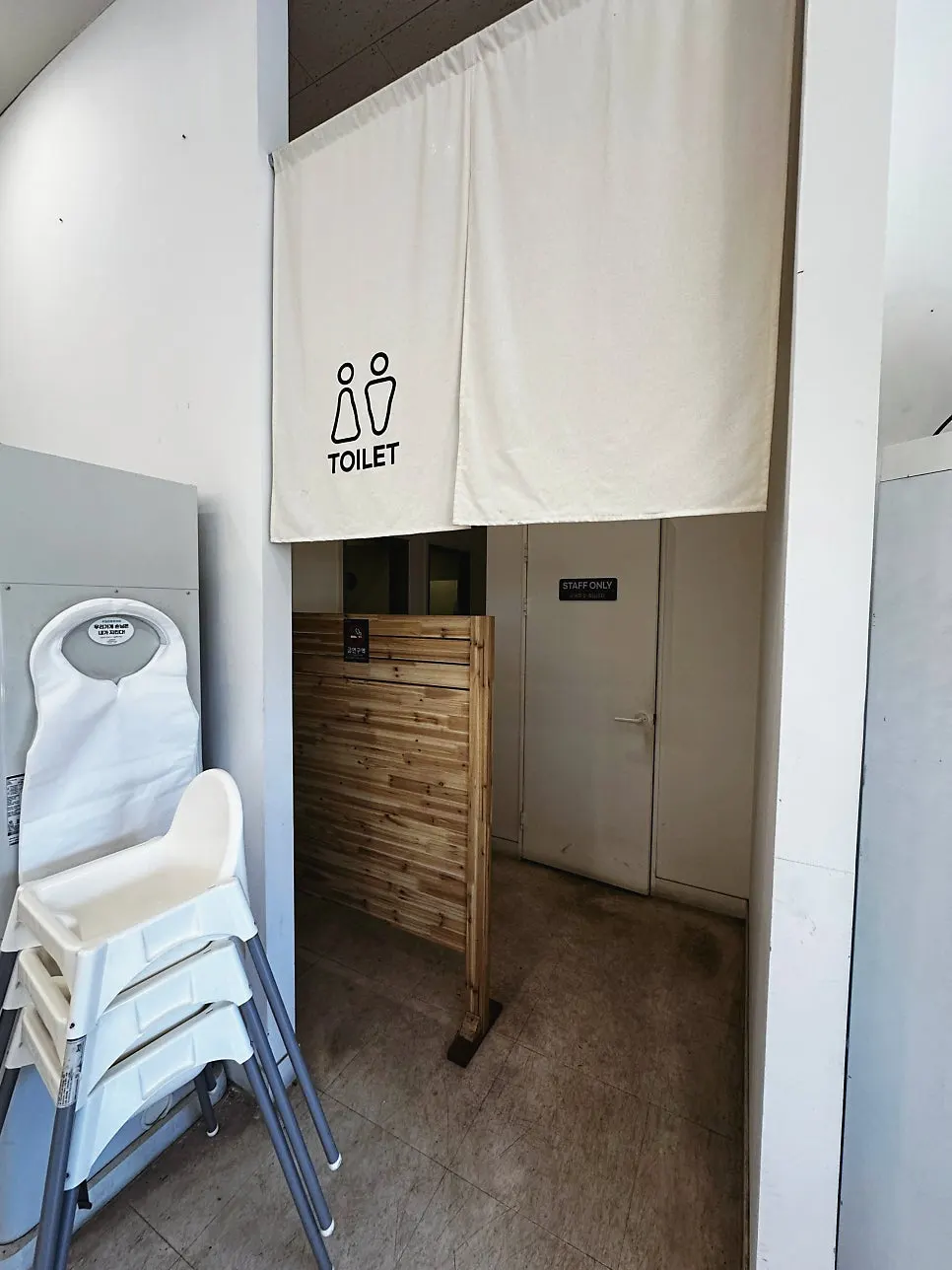 Entrance to the restroom and customer waiting room inside the restaurant