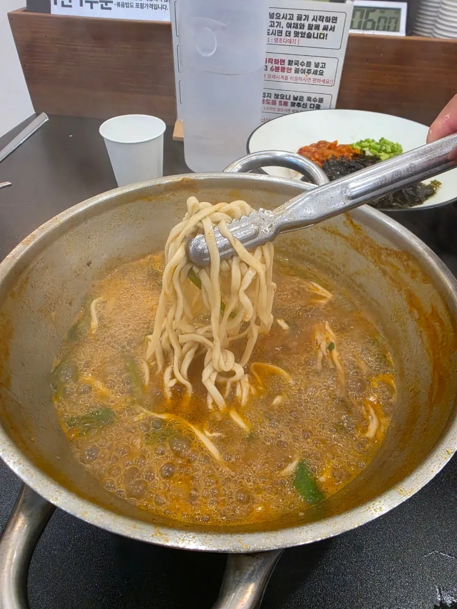 Regular kalguksu noodles added to the now-richer broth