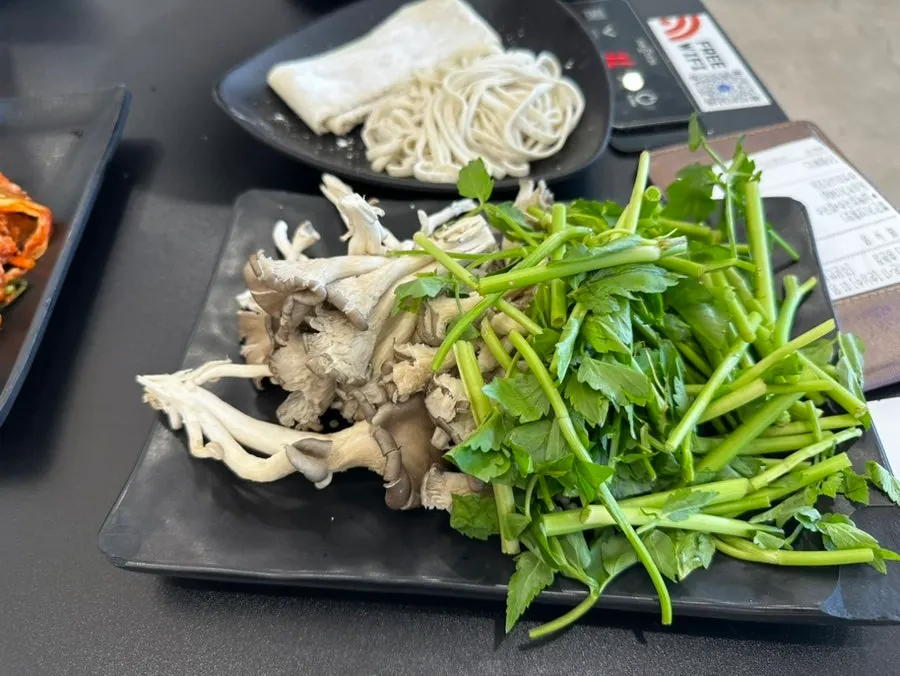 Spoons and chopsticks served sitting in warm water